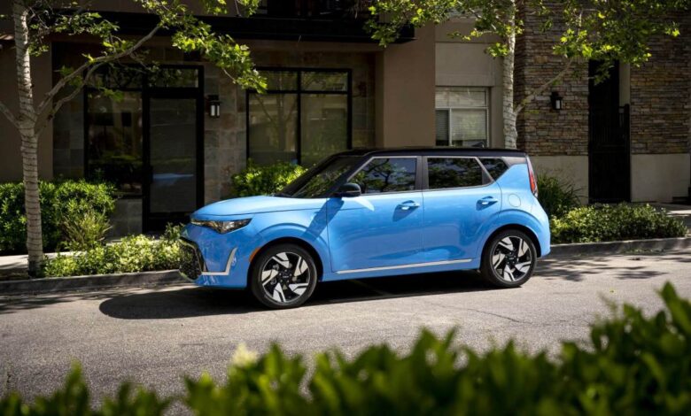 A light blue 2023 Kia Soul subcompact SUV/CUV model parked under tree shade