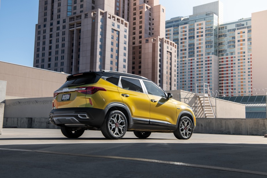 The 2023 Kia Seltos is an affordable AWD car with compact SUV styling, like this one in front of a city skyline.