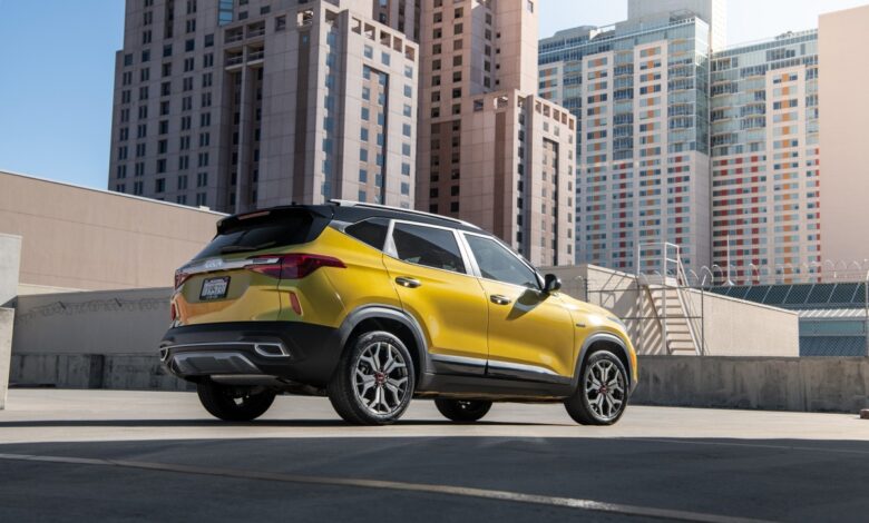 The 2023 Kia Seltos is a cheap AWD car with compact SUV styling, like this one in front of a city skyline.
