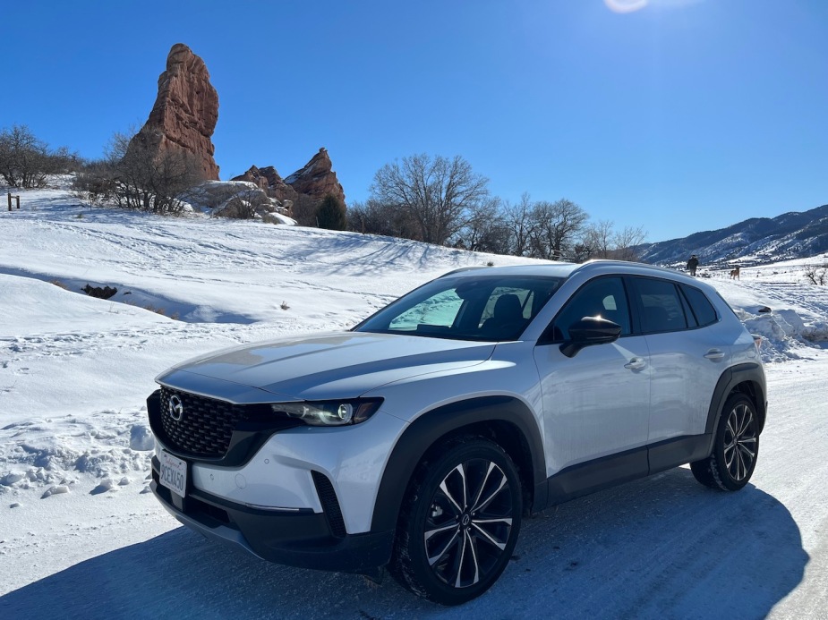 A white front exterior view of the 2023 Mazda CX-50 in the snow. 