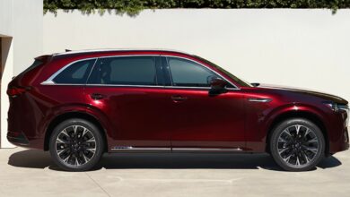 A red 2023 Mazda CX-90 midsize SUV is parked.