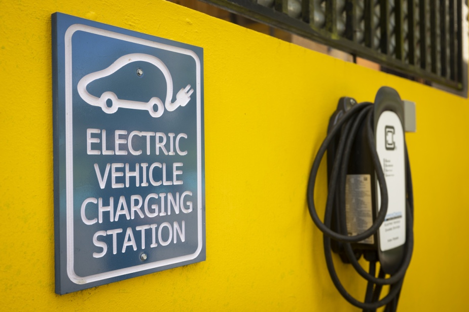 A yellow wall has an electric charging station and it's an EV that doesn't need a transfer case.
