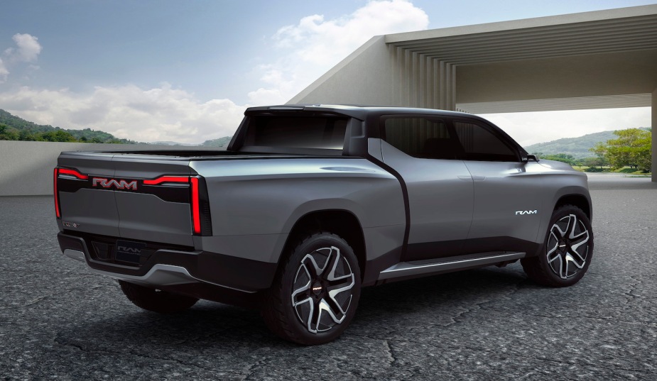 A promotional view of the rear of the Ram 1500 Revolution electric truck concept with a modern building in the background.