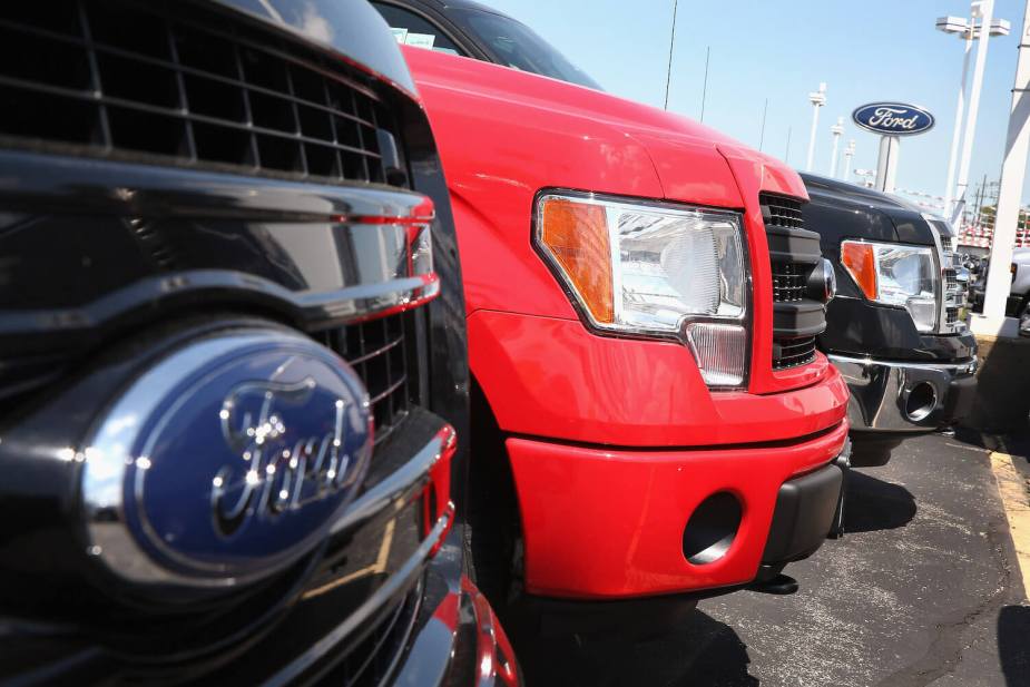 A row of 12th Generation (2013) Ford F-150 pickup trucks parked at a dealership in Illinois.