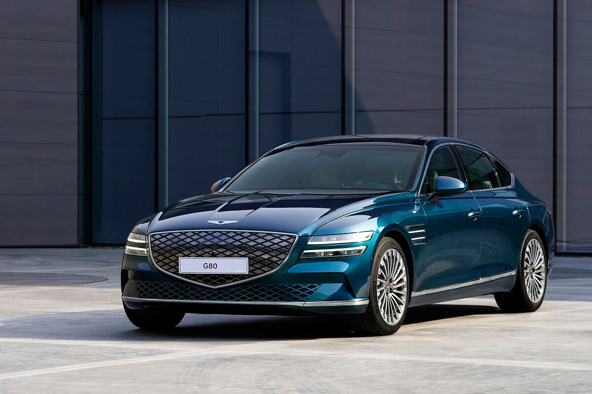 The Genesis Electrified G80 is seen in blue and green paint.