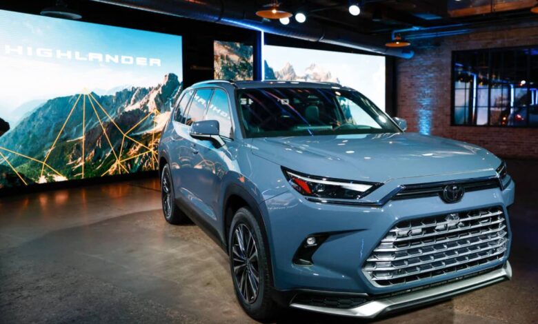 A blue 2024 Toyota Grand Highlander SUV is displayed at the Chicago Auto Show.
