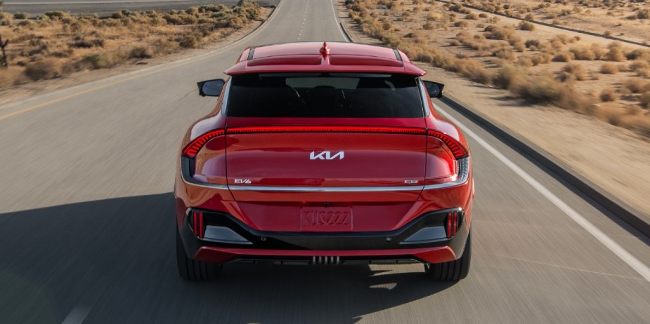 The back of a small red Kia EV6 electric SUV.