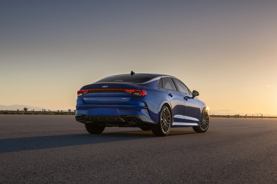 The blue 2023 Kia K5 LXS shows off its rear end at sunset. 