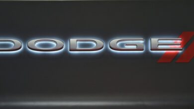 A backlit Dodge logo on a black background.
