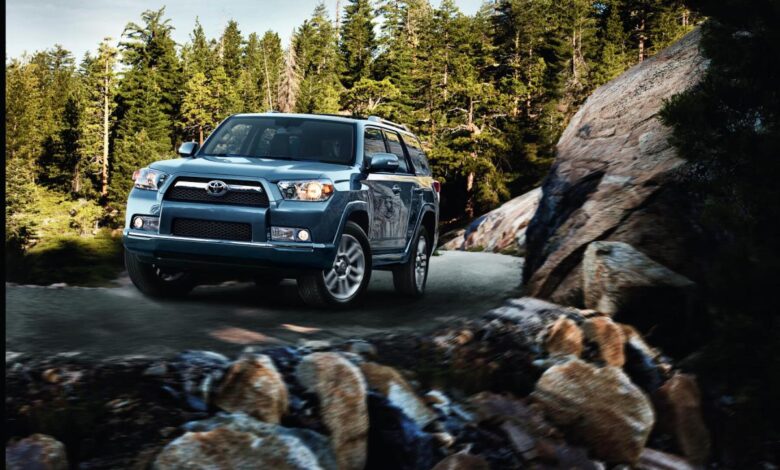 2013 Toyota 4Runner with rocks in foreground and trees in background.