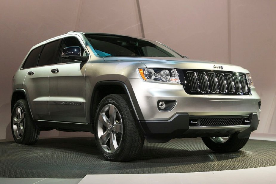 One of the least reliable cars around, the 2011 Jeep Grand Cherokee showcases its styling on stage.