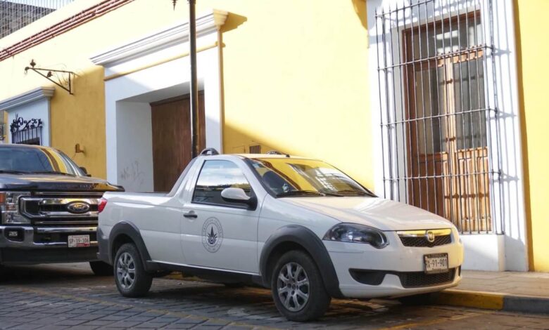 A white, two door Ram 700 compact truck parked on the street in Mexico.
