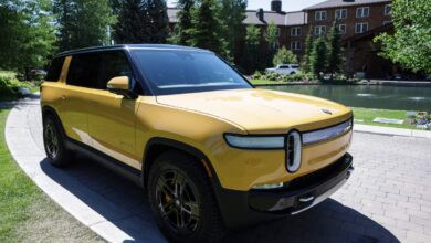 A yellow 2022 Rivian R1S parked outdoors.