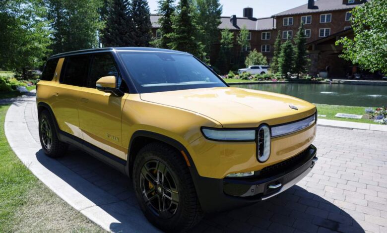 A yellow 2022 Rivian R1S parked outdoors.