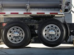 Why don't some semi-truck tires touch the ground?