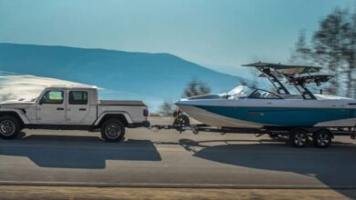 The 2023 Jeep Gladiator is towing a boat. It is the last midsize pickup with a diesel powertrain.