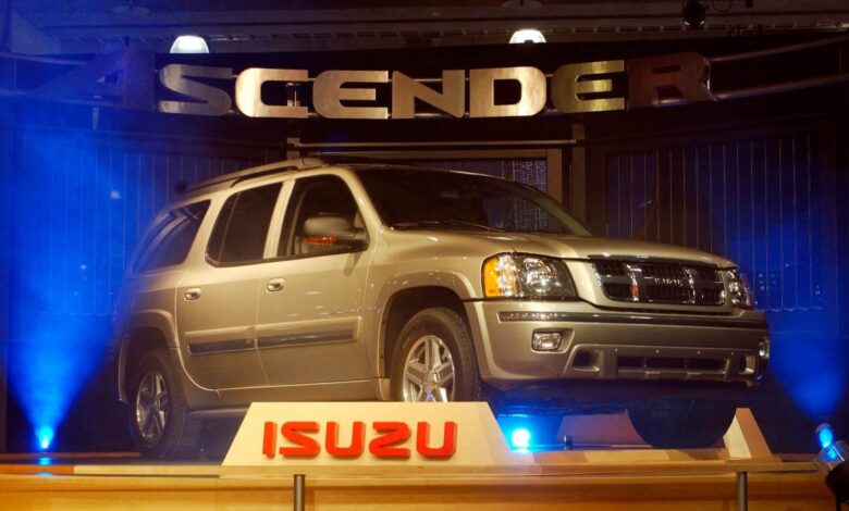 The Isuzu Ascender release event - featuring a silver SUV backlit with blue lights.