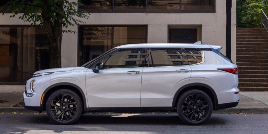 A small white 2023 Mitsubishi Outlander SUV is parked. 